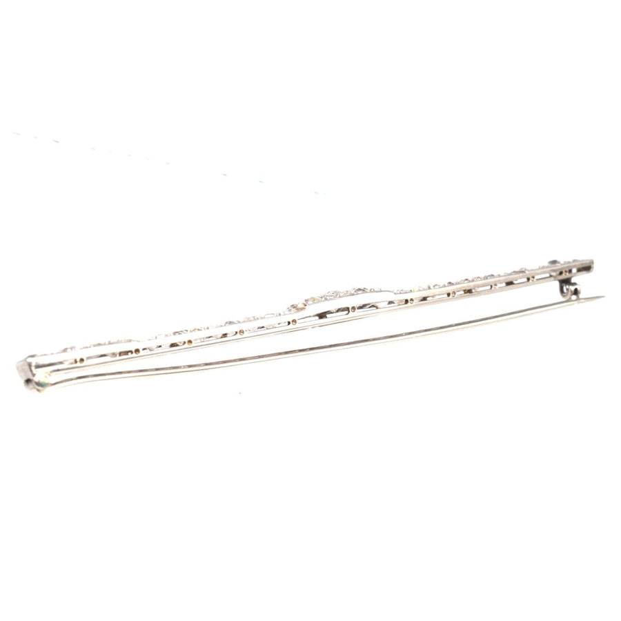 Large Art Deco platinum diamond bar brooch with intricate design and sparkling diamonds.
