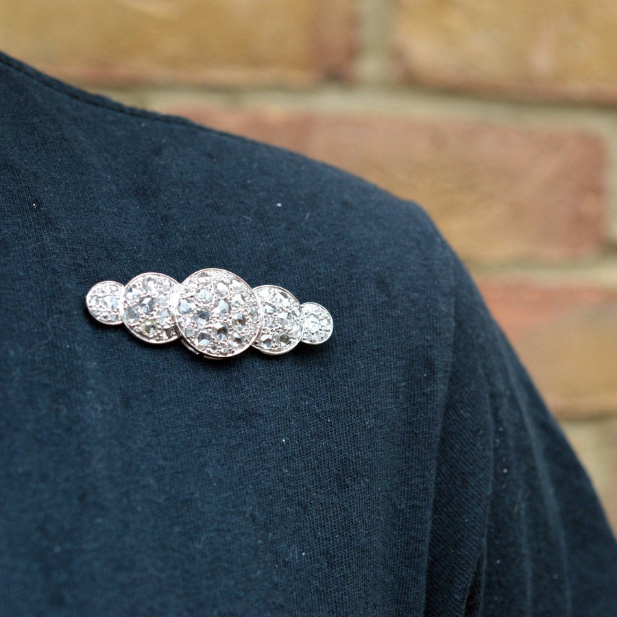 Large Art Deco rose cut diamond quintuple circle brooch on a dark shirt, showcasing vintage elegance from the 1930s.