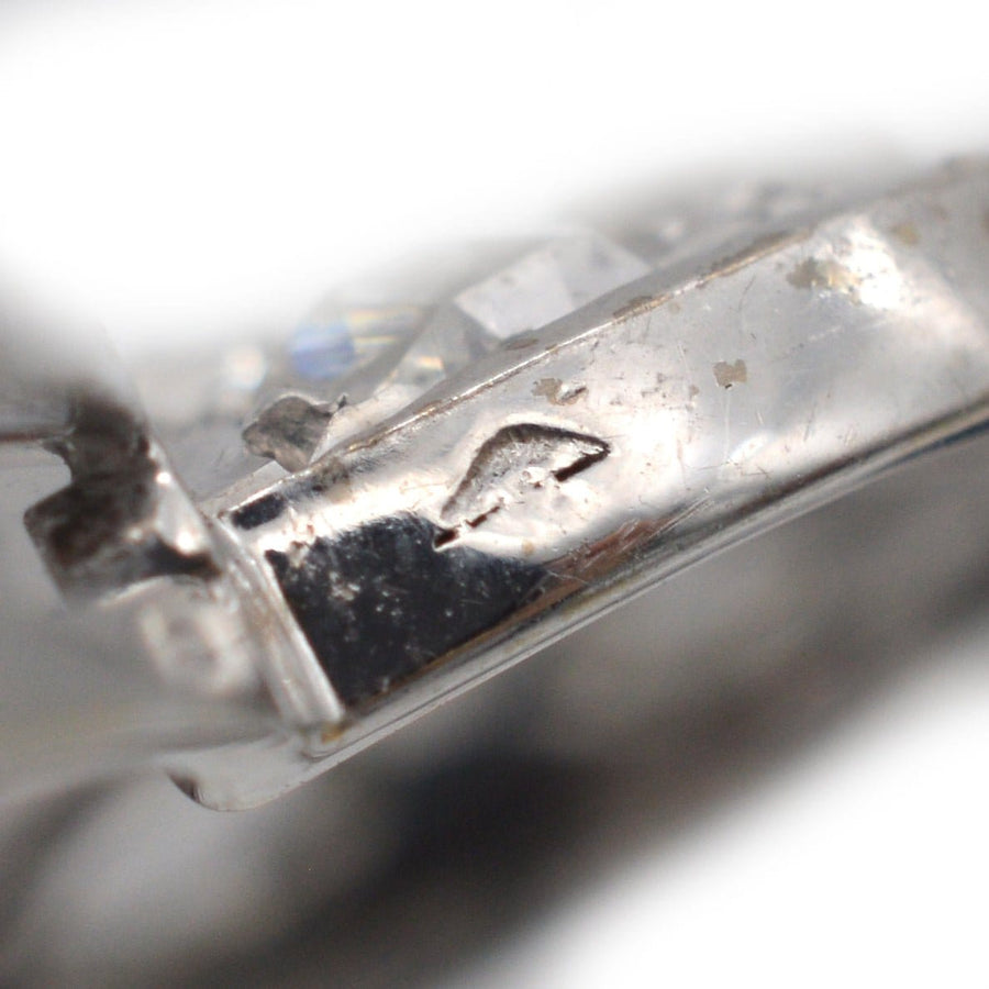 Close-up of the hallmark on a vintage Art Deco brooch, showcasing fine details and craftsmanship from the 1930s.