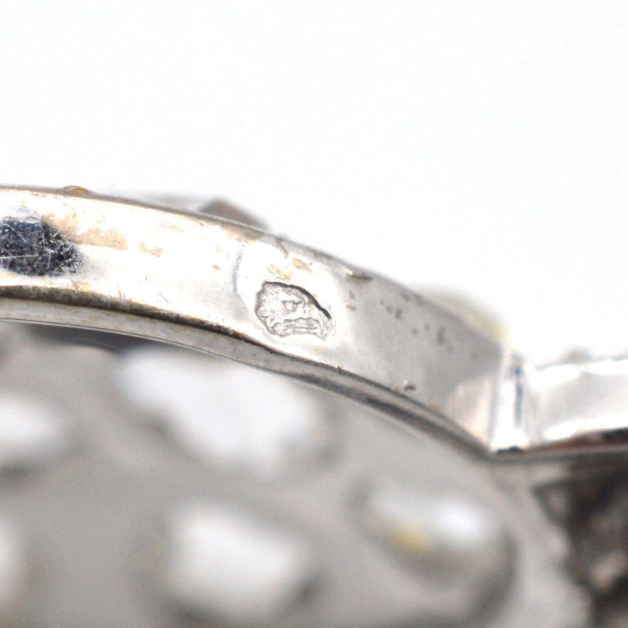 Close-up of the vintage brooch's inner silver mark, showcasing intricate detailing from the 1930s Art Deco design.