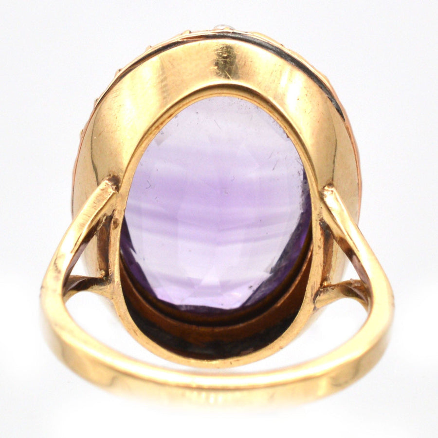 Large Edwardian 15ct gold amethyst and natural split pearl cocktail ring, showcasing intricate design and rich purple stone.