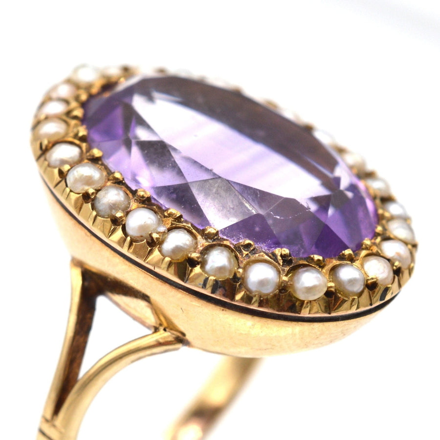 Large Edwardian 15ct gold ring featuring an oval amethyst surrounded by natural split pearls.