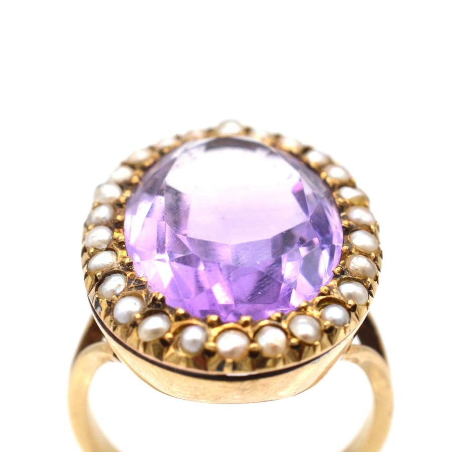 Large Edwardian 15ct gold cocktail ring featuring an oval amethyst surrounded by natural seed pearls.