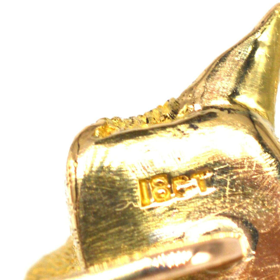 Close-up of 18ct gold hallmark on an Edwardian fox tie pin, showcasing its quality and craftsmanship.