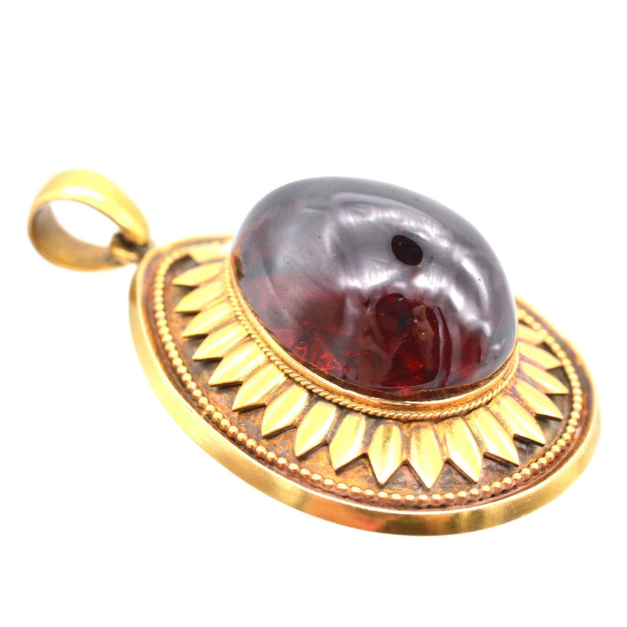 Large Victorian 15ct gold cabochon garnet pendant with floral gold detailing, circa 1860s-1880s.