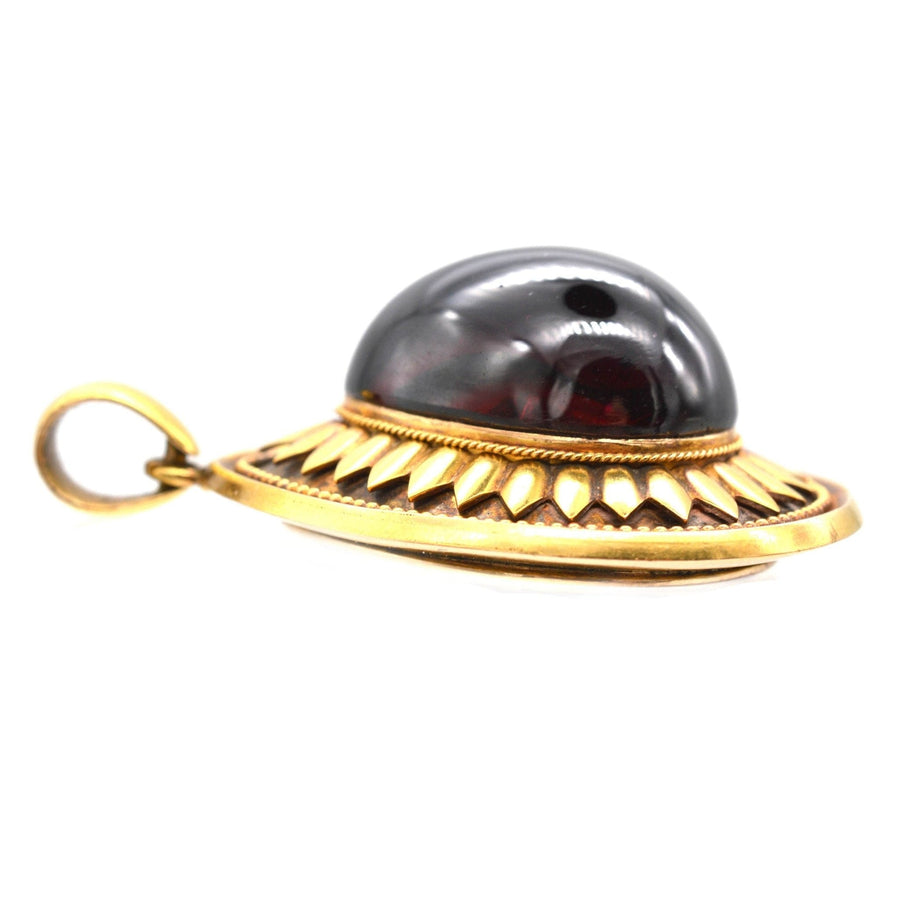 Large Victorian 15ct gold cabochon garnet pendant with intricate gold detailing.