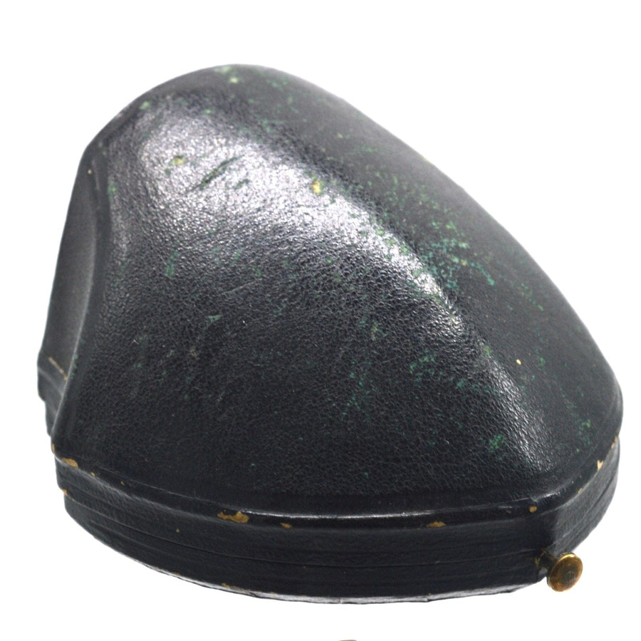 Vintage black case for brooch with green patina and gold accents, perfect for jewelry storage.