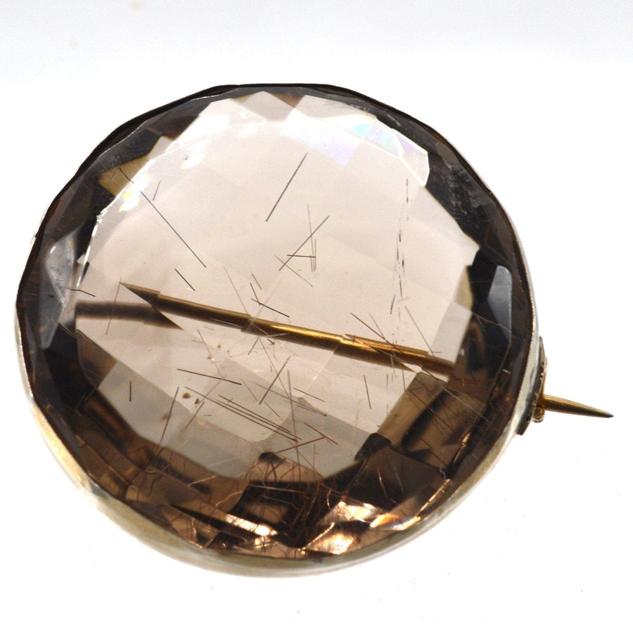Large Victorian silver brooch featuring rutilated quartz with golden strands, displayed in original case.