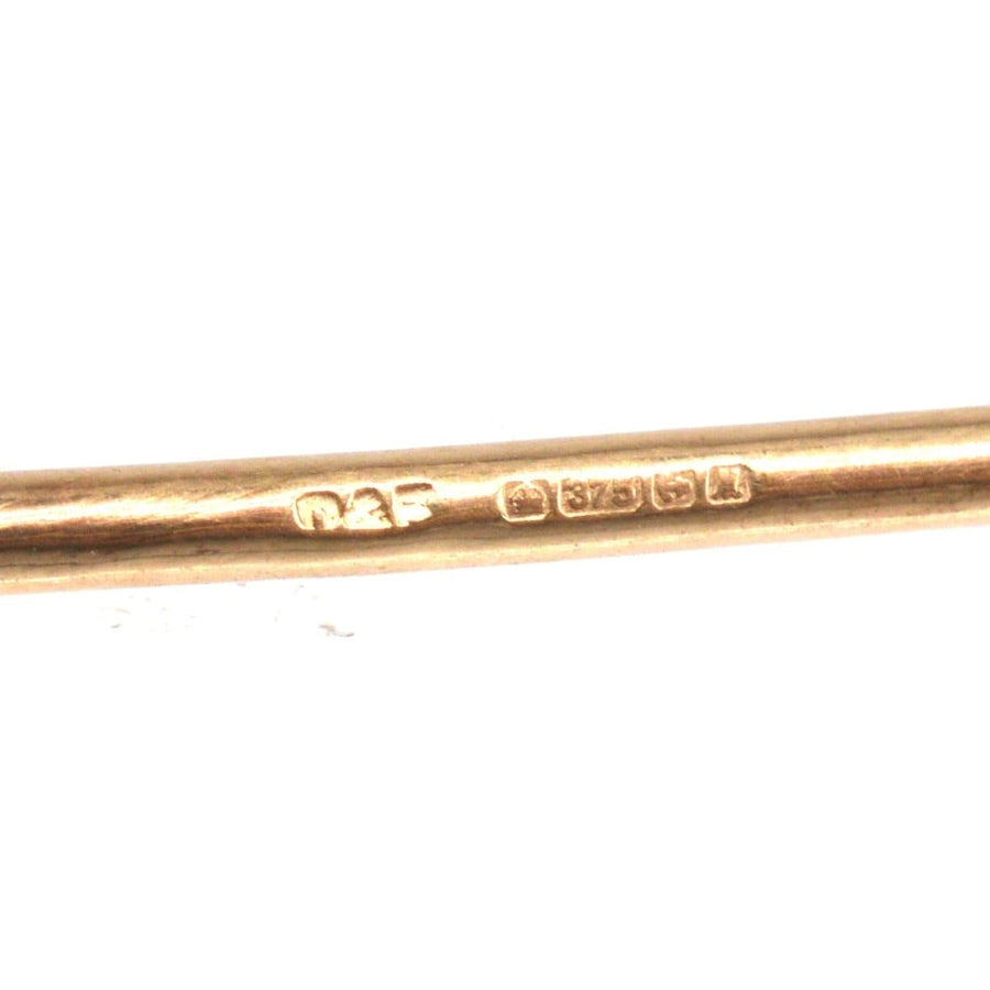 Close-up of vintage 9ct gold stock pin brooch hallmark by Deakin & Francis.