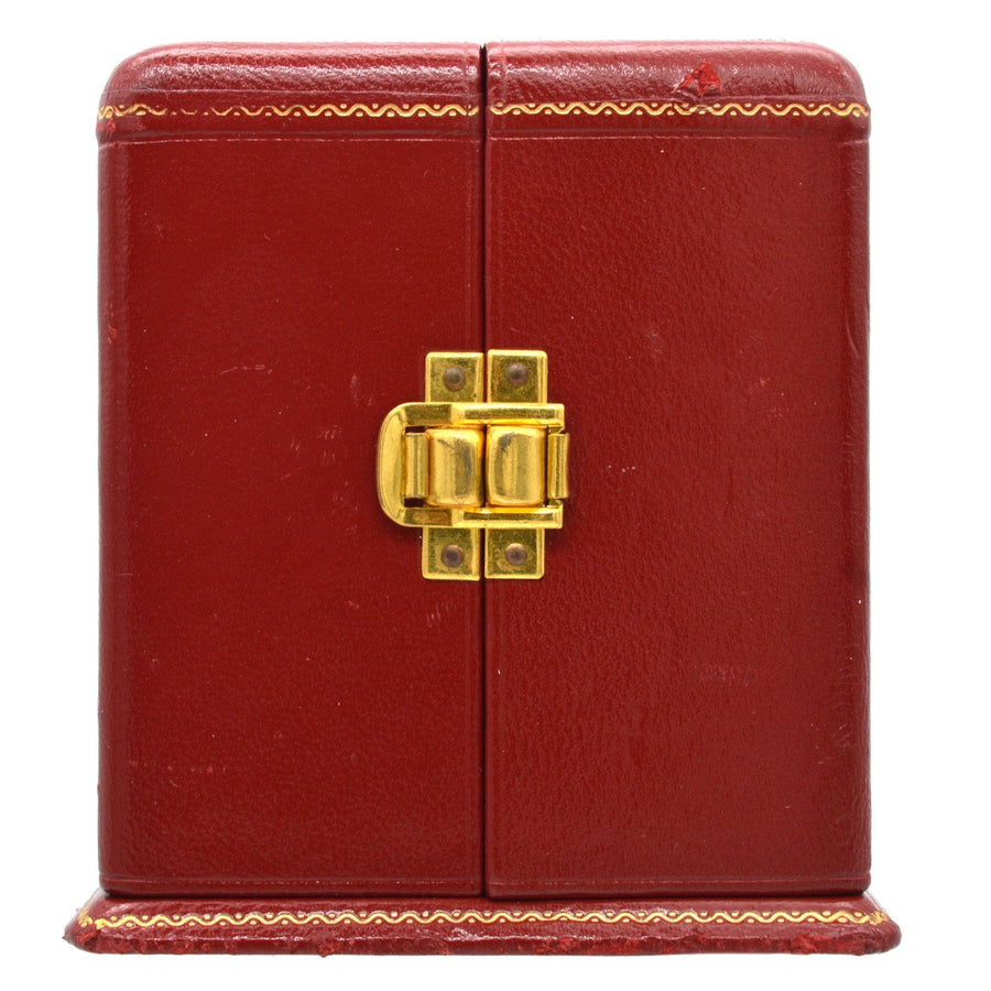 Red leather clock case with gold clasp and decorative trim, designed for a vintage mantlepiece clock.