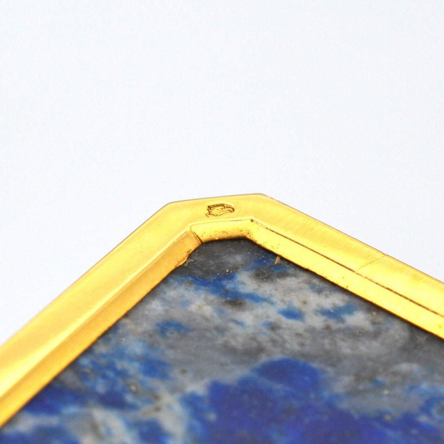 Close-up of 18ct gold edging on lapis lazuli clock, showcasing craftsmanship and detail.