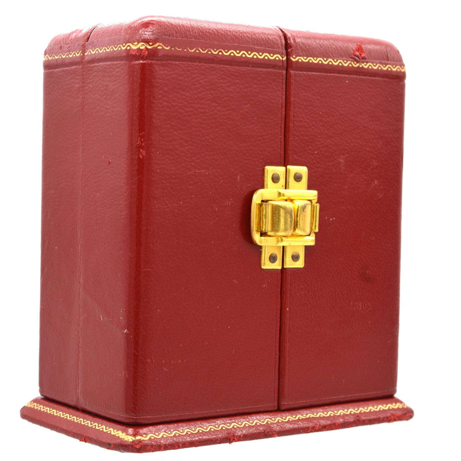 Vintage red leather case with gold clasp, designed for a decorative clock.