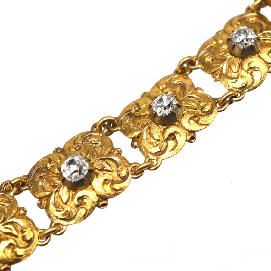 Late 19th century Art Nouveau gold bracelet featuring ornate foliage design and old mine cut diamonds.