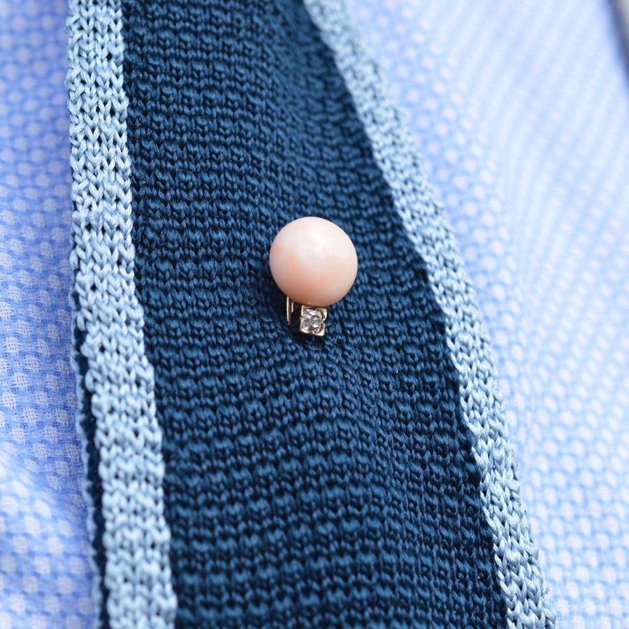 Late Victorian 15ct gold tie pin featuring Angel Skin Coral and old mine cut diamond, styled on a textured blue tie.