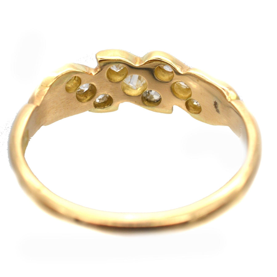 View of an 18ct gold ring showcasing old mine cut diamonds in a unique rope twist design.