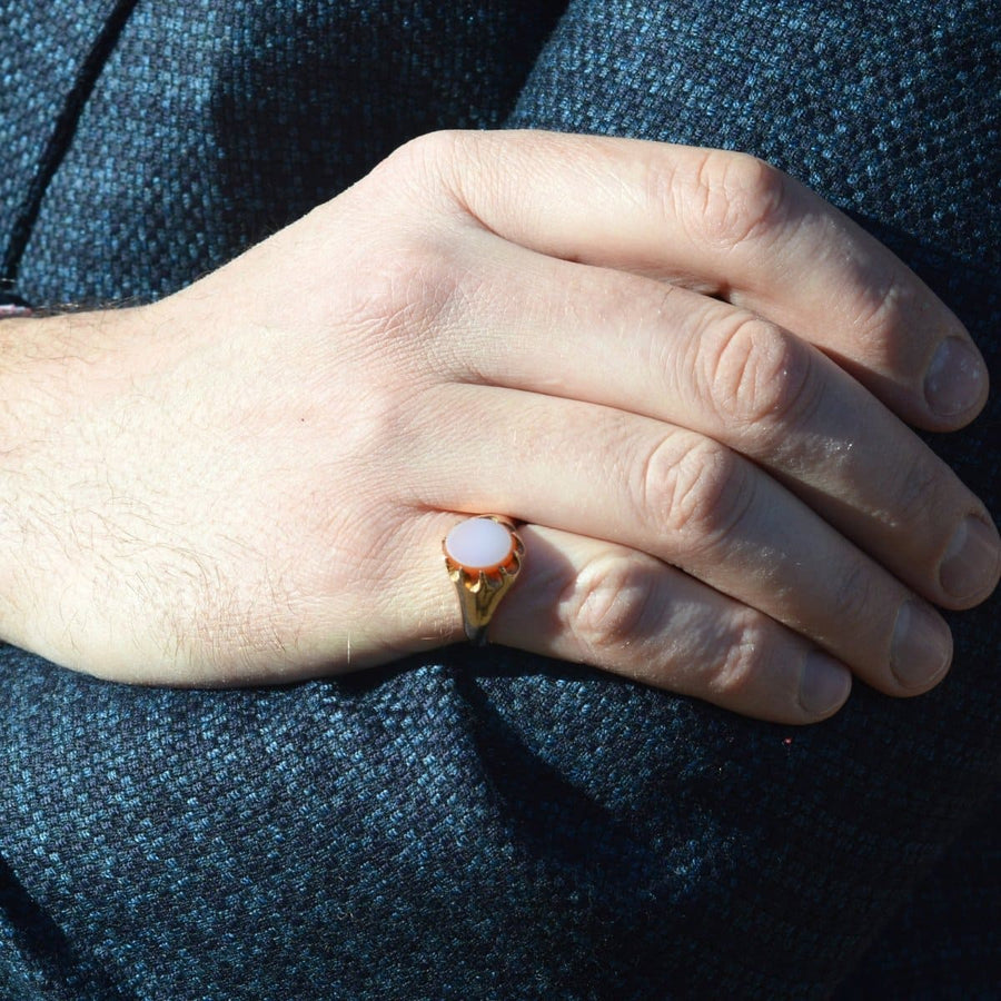 Late Victorian 9ct gold sardonyx signet ring worn on hand, showcasing its elegant design and stone.