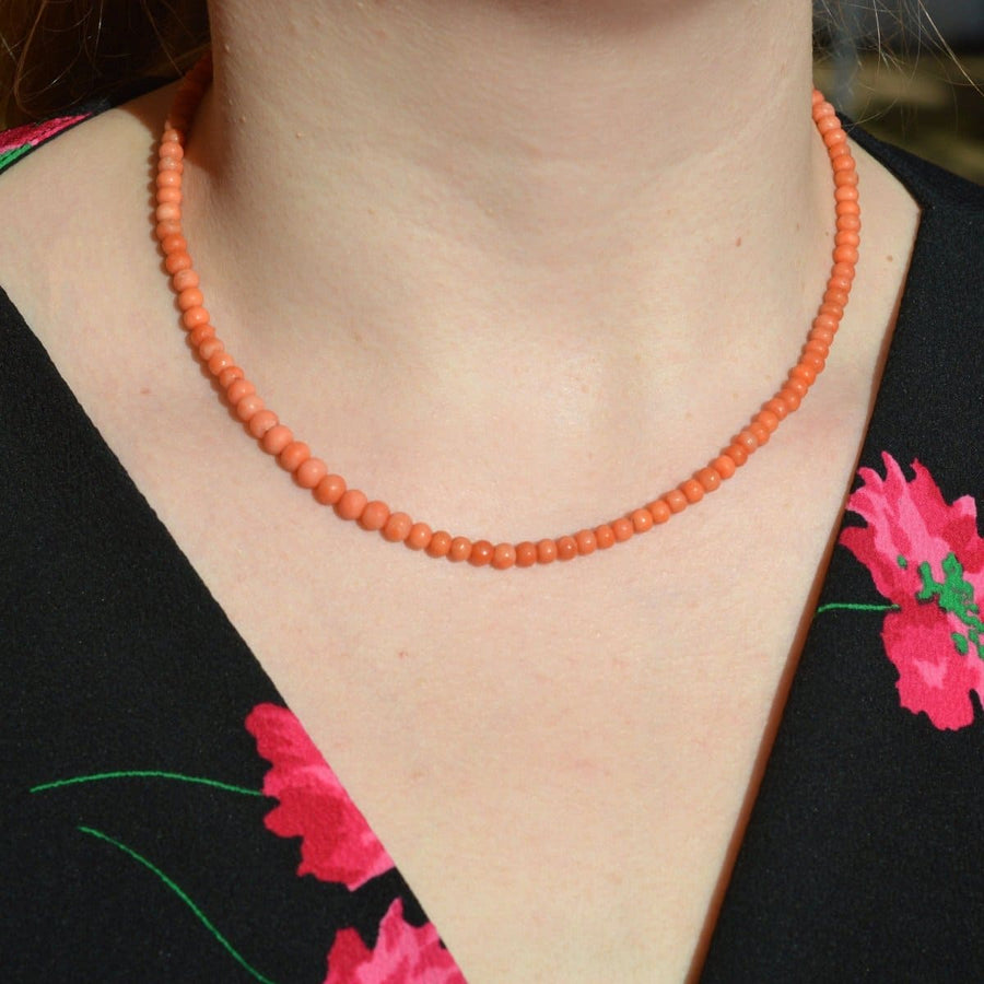Mid 19th Century salmon coral bead necklace showcasing healing properties, worn as a traditional Christening gift.