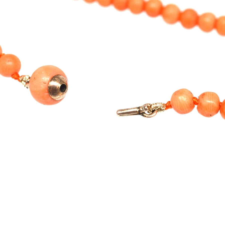 Mid 19th Century gold coral bead necklace featuring salmon coral beads and secure gold clasp.