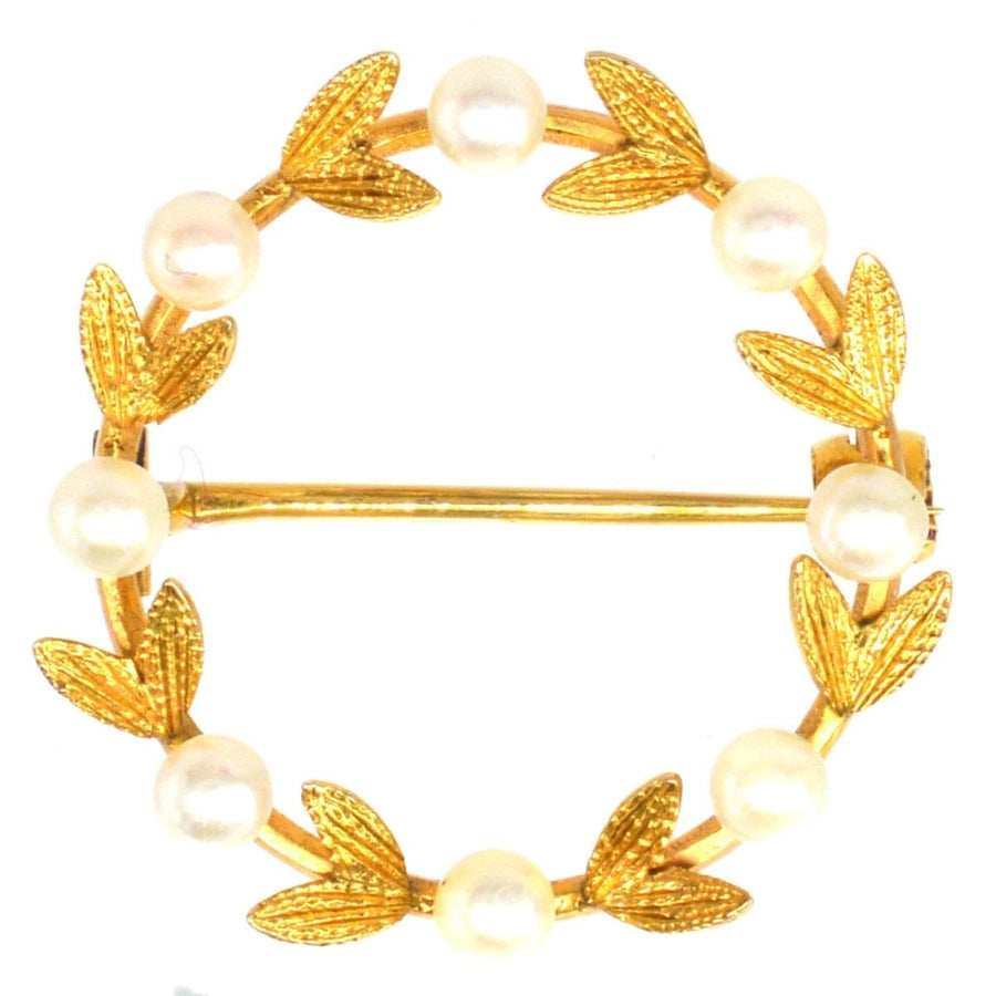 Mid 20th Century gold and cultured pearl laurel wreath brooch, symbolizing triumph with elegant leaf design.