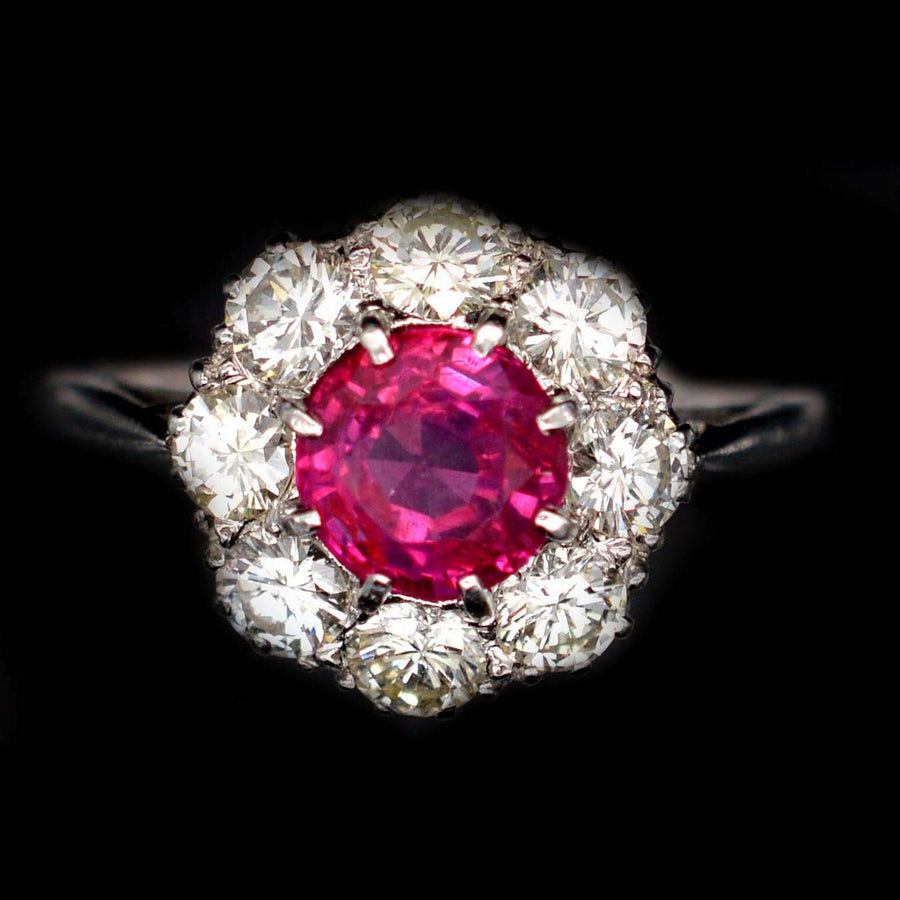 Mid 20th century platinum ring featuring a 1.7 carat Burmese ruby surrounded by eight diamonds.
