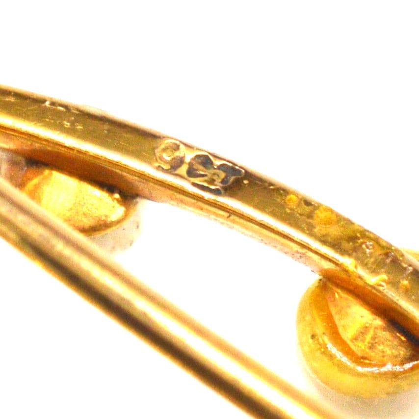 Close-up of a 9ct gold marquise bar brooch showcasing the hallmark and refined craftsmanship.
