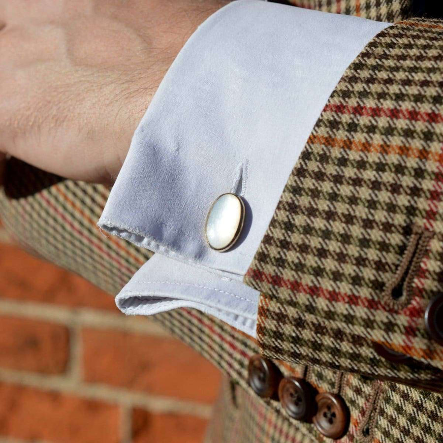 Mid century German silver mother of pearl cufflinks worn on a light blue shirt cuff, showcasing timeless elegance.