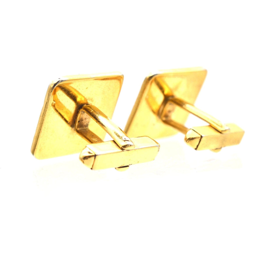 Vintage Norman Hartnell gold cufflinks with a square design, part of a jewelry set in original box.