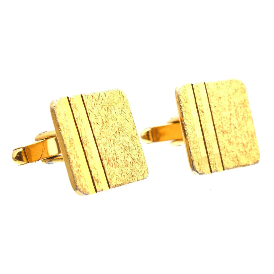 Vintage Norman Hartnell cufflinks in gold, featuring a textured square design with double stripes.