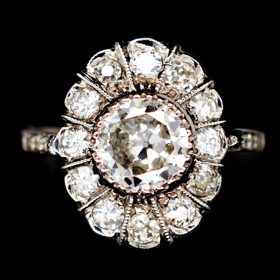 Mid Century 18ct white gold oval diamond cluster ring featuring a stunning 1 carat center diamond, circa 1960.