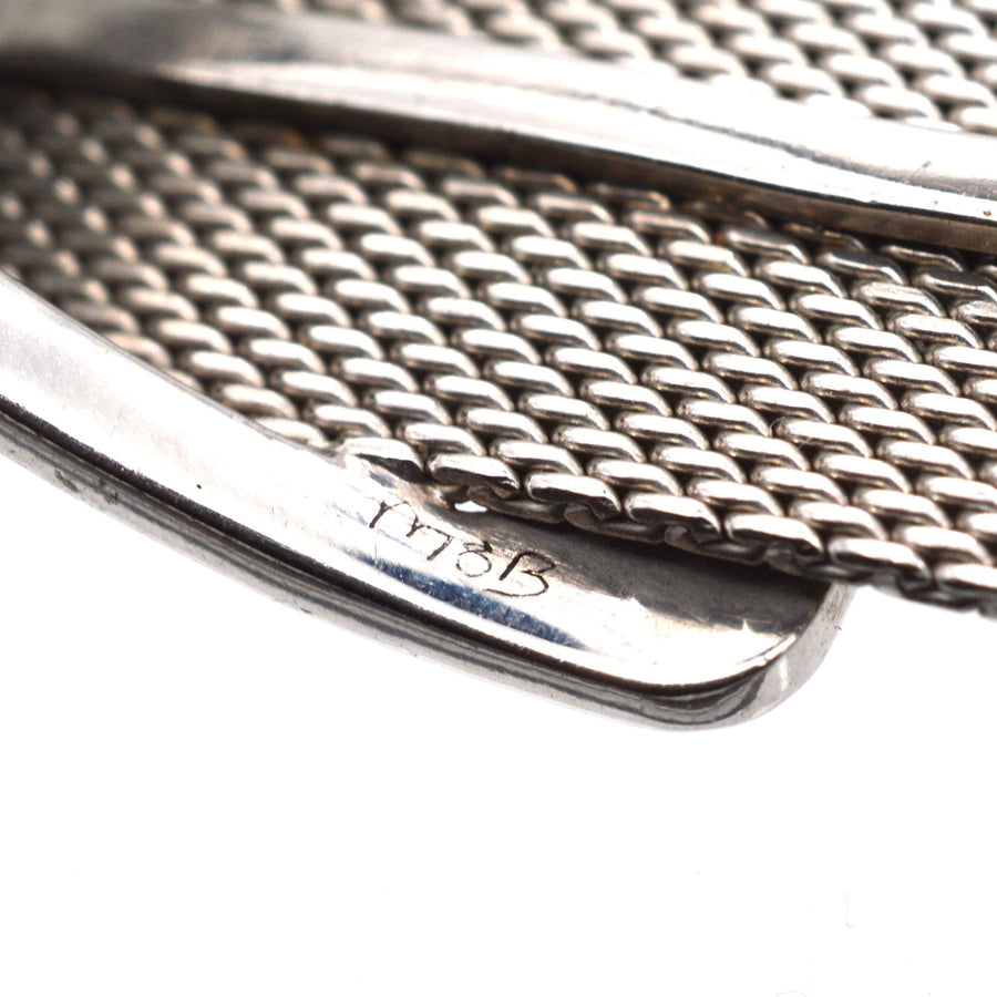 Close-up of a vintage silver buckle brooch with marcasite detailing, showcasing craftsmanship and intricate design.