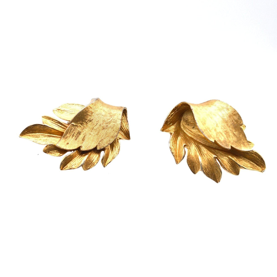 Mid Century Trifari gilt metal leaf earrings, showcasing stunning baroque design in golden tones.