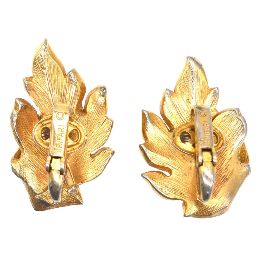 Mid Century Trifari gilt metal leaf earrings in striking gold, showcasing a baroque style for a dramatic look.