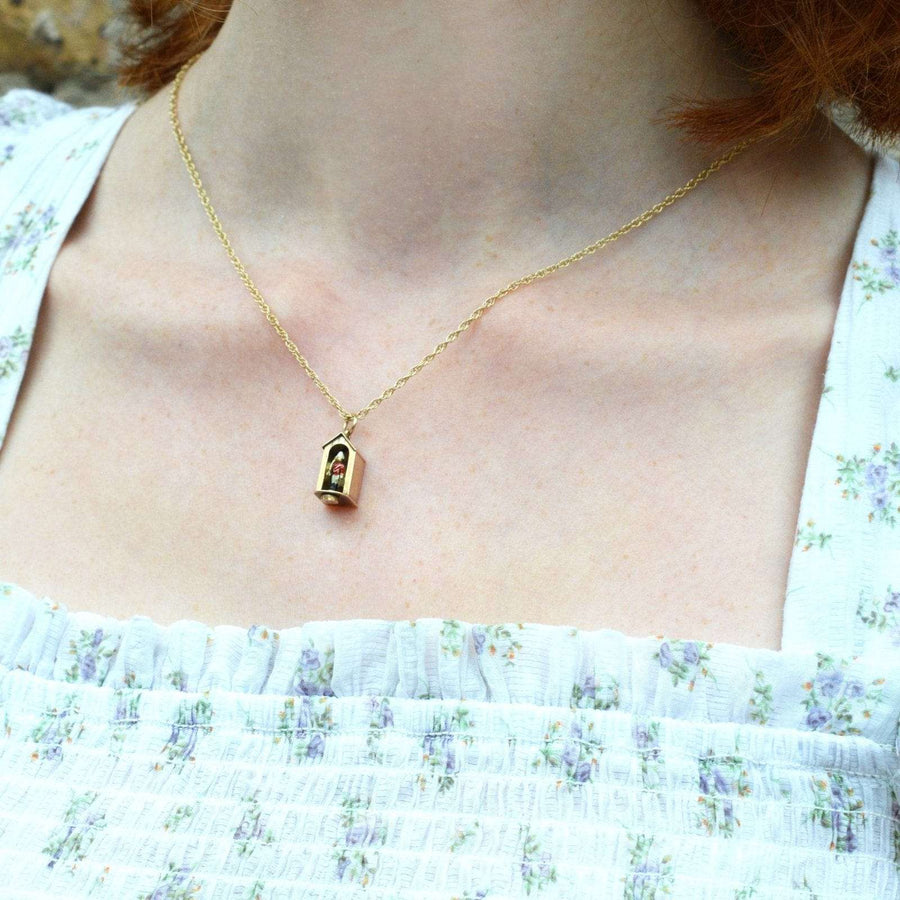 Gold and enamel charm necklace featuring a miniature Queen's Life Guard in a sentry box.