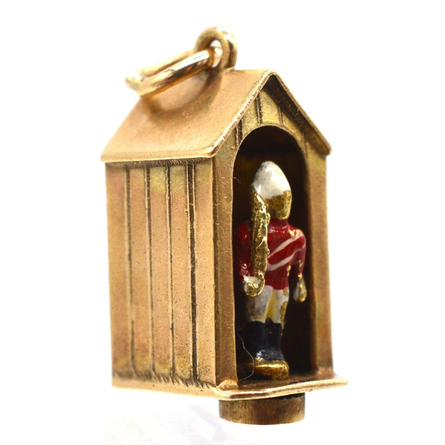 Miniature gold and enamel charm featuring a Queen's Life Guard in a sentry box by Georg Jensen Ltd.