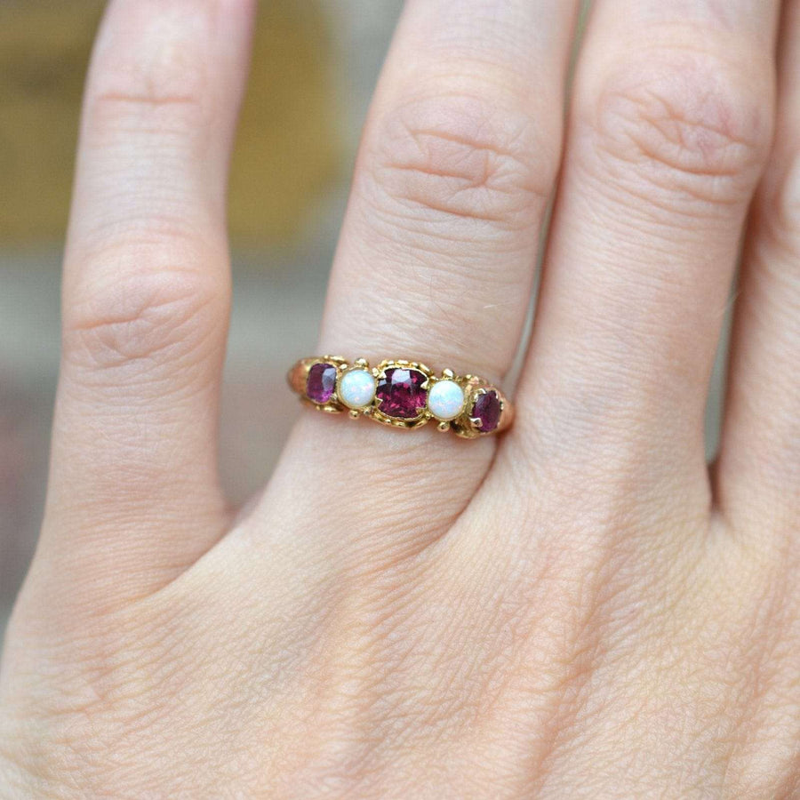 Regency 15ct gold ring featuring garnet and opal, perfect for engagement or a stunning jewelry collection accent.