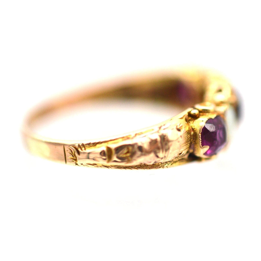 Regency 15ct gold ring featuring garnet and opal stones in an intricate floral setting.