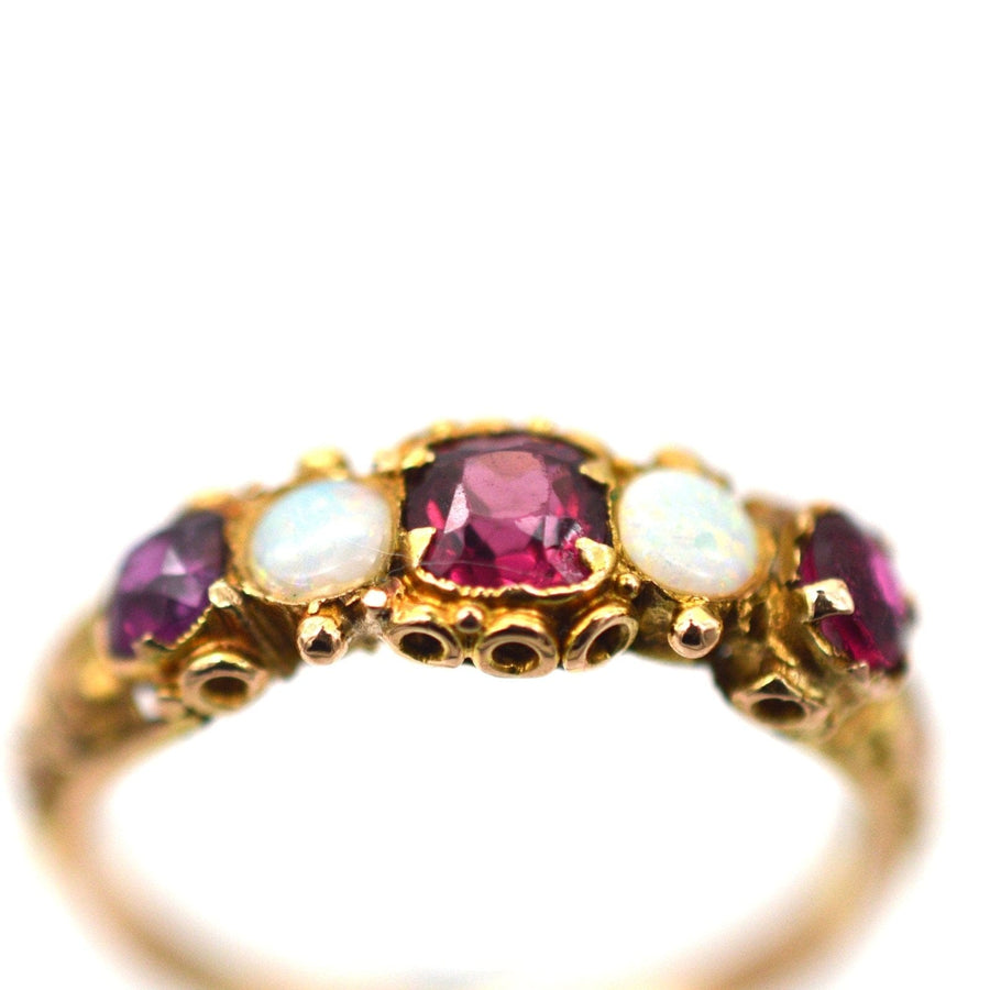 Regency 15ct gold five stone ring featuring garnets and opals, perfect for engagement or adding to a jewelry collection.