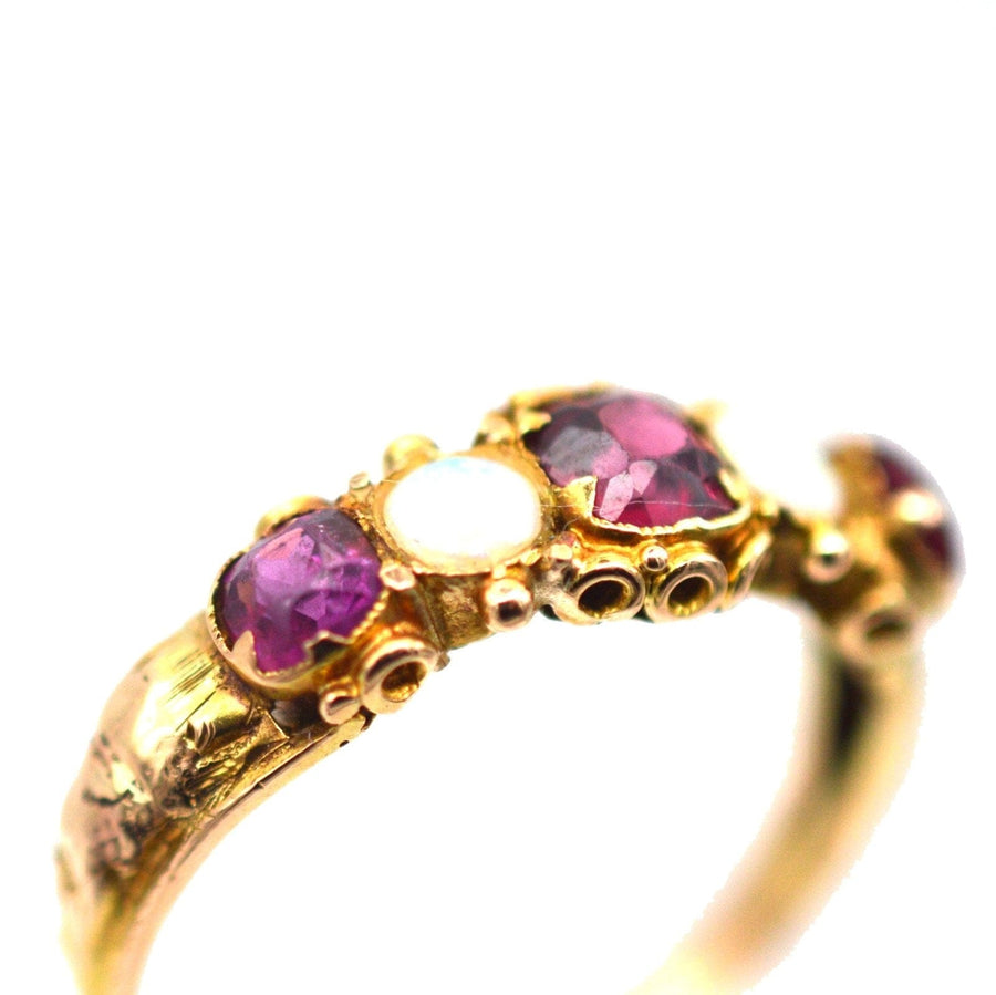 Delicate Regency 15ct gold ring featuring garnets and opals in an intricate setting, ideal for engagement or collection.