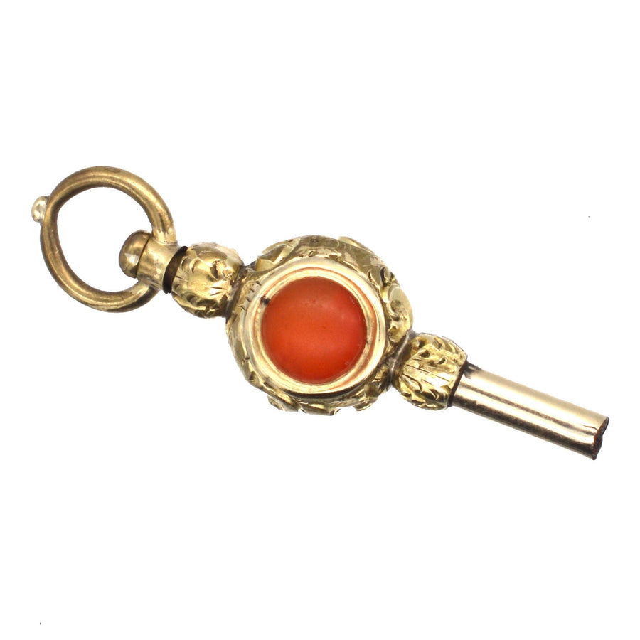 Elegant Regency gold cased watch key pendant with carnelian and white chalcedony, showcasing intricate design.