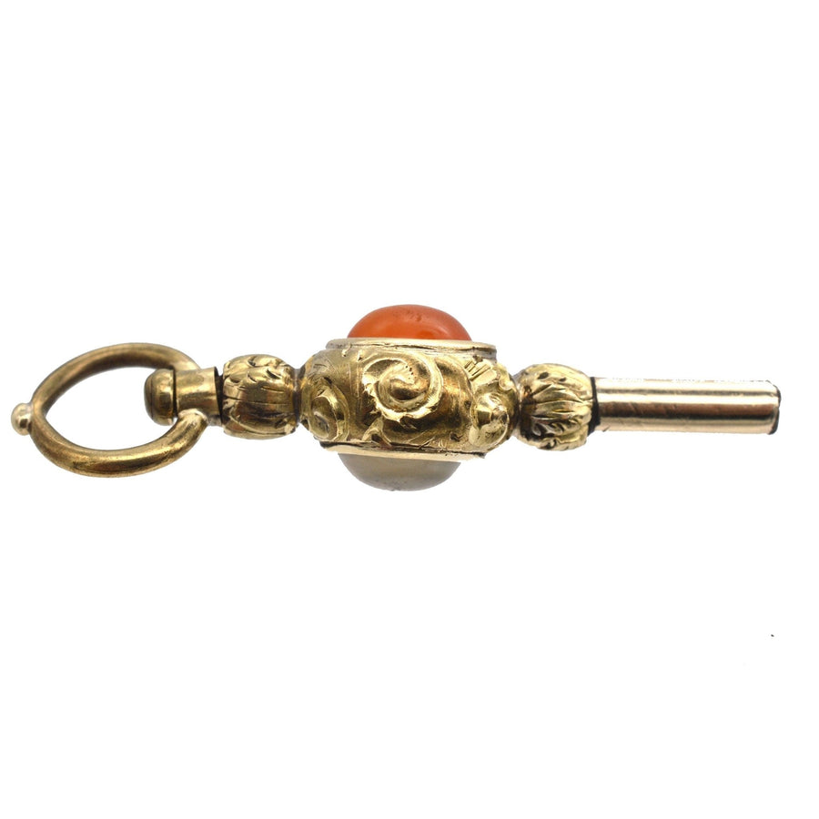 Regency gold cased watch key pendant adorned with carnelian and white chalcedony, elegant and quirky jewelry.