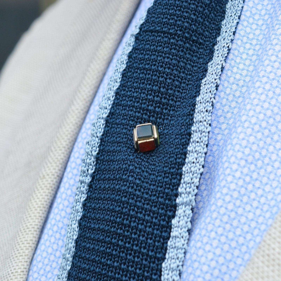 Scottish Victorian 9ct gold cube tie pin featuring bloodstone, chalcedony, and carnelian on a navy textured tie.