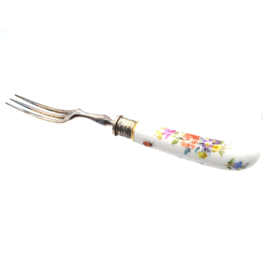 Late 19th century silver fork with painted Meissen porcelain handle featuring floral design.