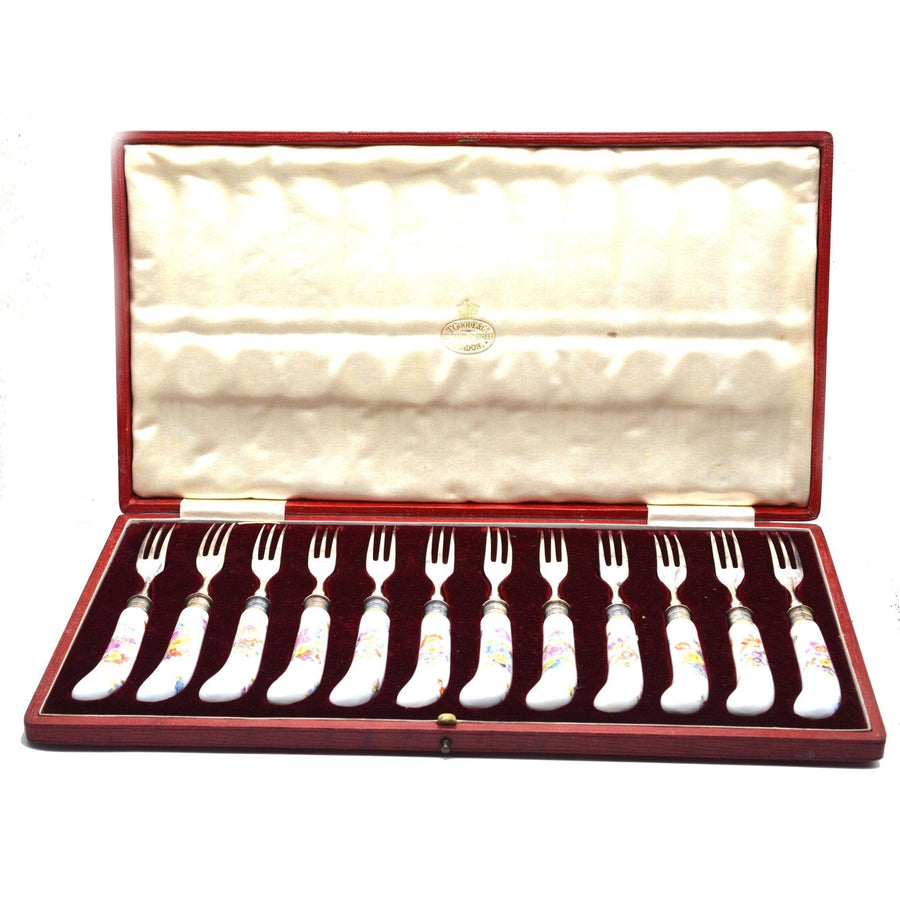 Set of 12 Thomas Goode silver forks with painted Meissen porcelain handles in original leather case.