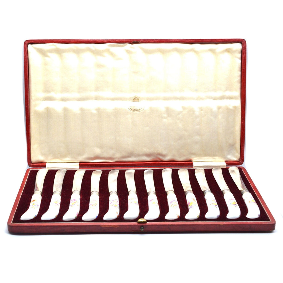 Set of 12 Thomas Goode silver cutlery with painted Meissen porcelain handles in original red leather case.