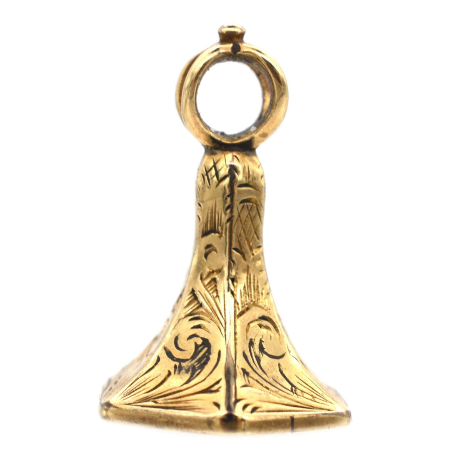 Tiny Early Victorian 9ct gold intaglio seal featuring intricate engraving and a loop for attaching to jewelry.