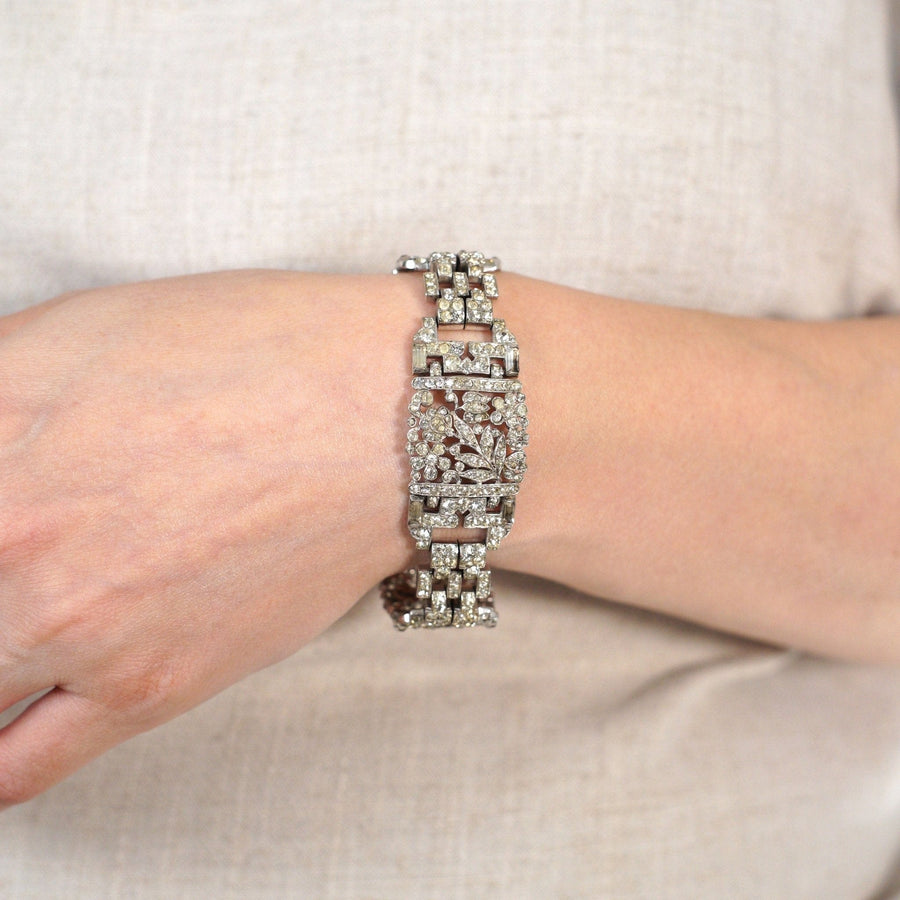 Trifari 1940s silver-tone wide bracelet with white paste, stylish and sparkly, reminiscent of vintage jewelry.