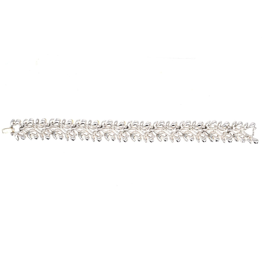 1950s Trifari white "diamond" paste bracelet with floral wreath design, featuring elegant sparkling stones.