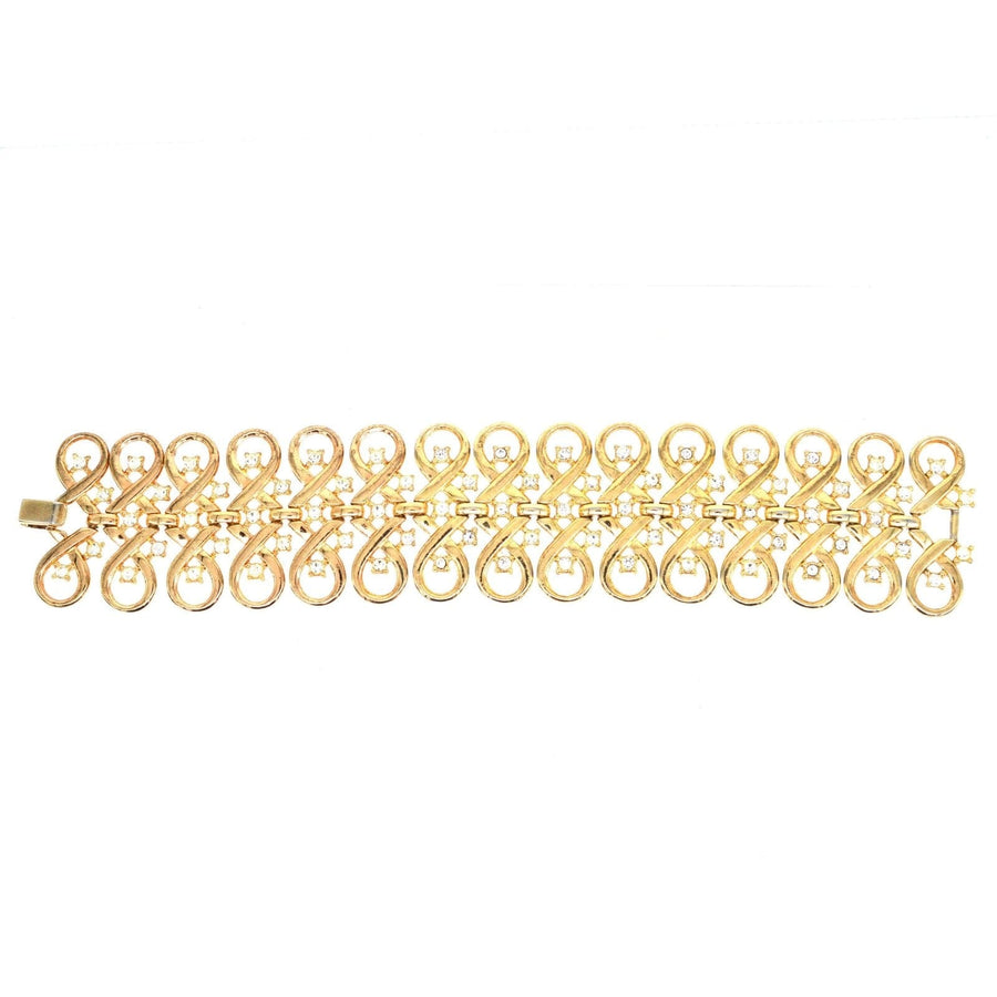 Trifari gold-tone paste bracelet featuring interlinked swirls and diamond pastes, vintage collectible jewelry.