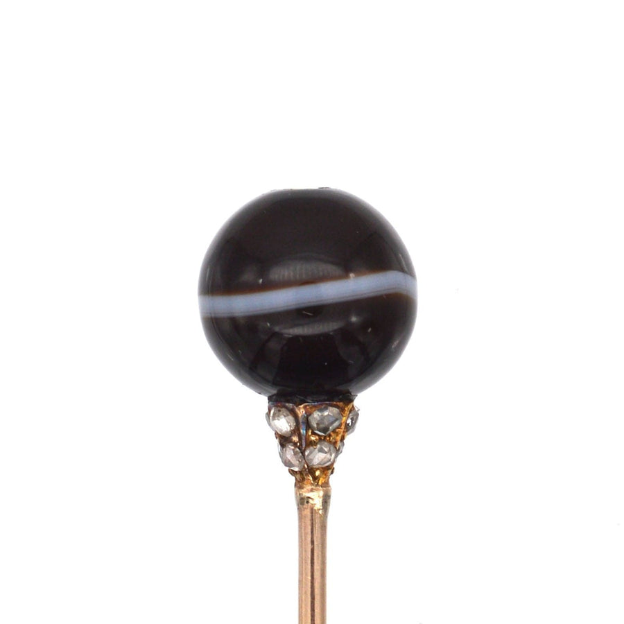 Victorian 15ct gold tie pin featuring a banded onyx sphere and diamond-studded mount for an elegant touch.