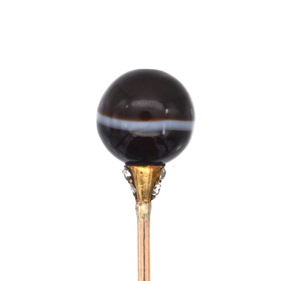 Victorian 15ct gold tie pin featuring a banded onyx sphere and diamond mount, perfect for elegant silk ties.